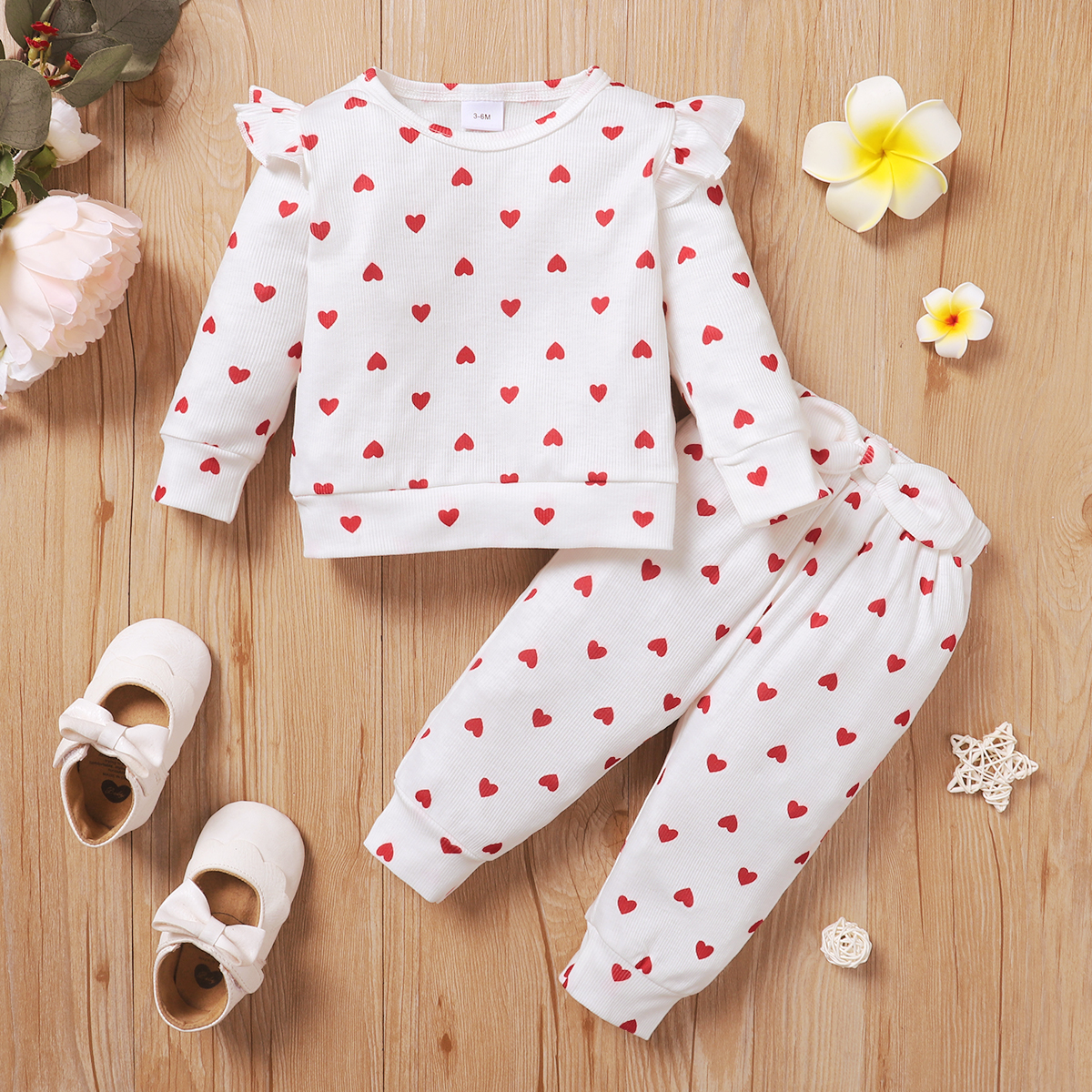 

2pcs Baby Girl Allover Love Heart Print White Ribbed Ruffle Long-sleeve Top and Bowknot Pants Set