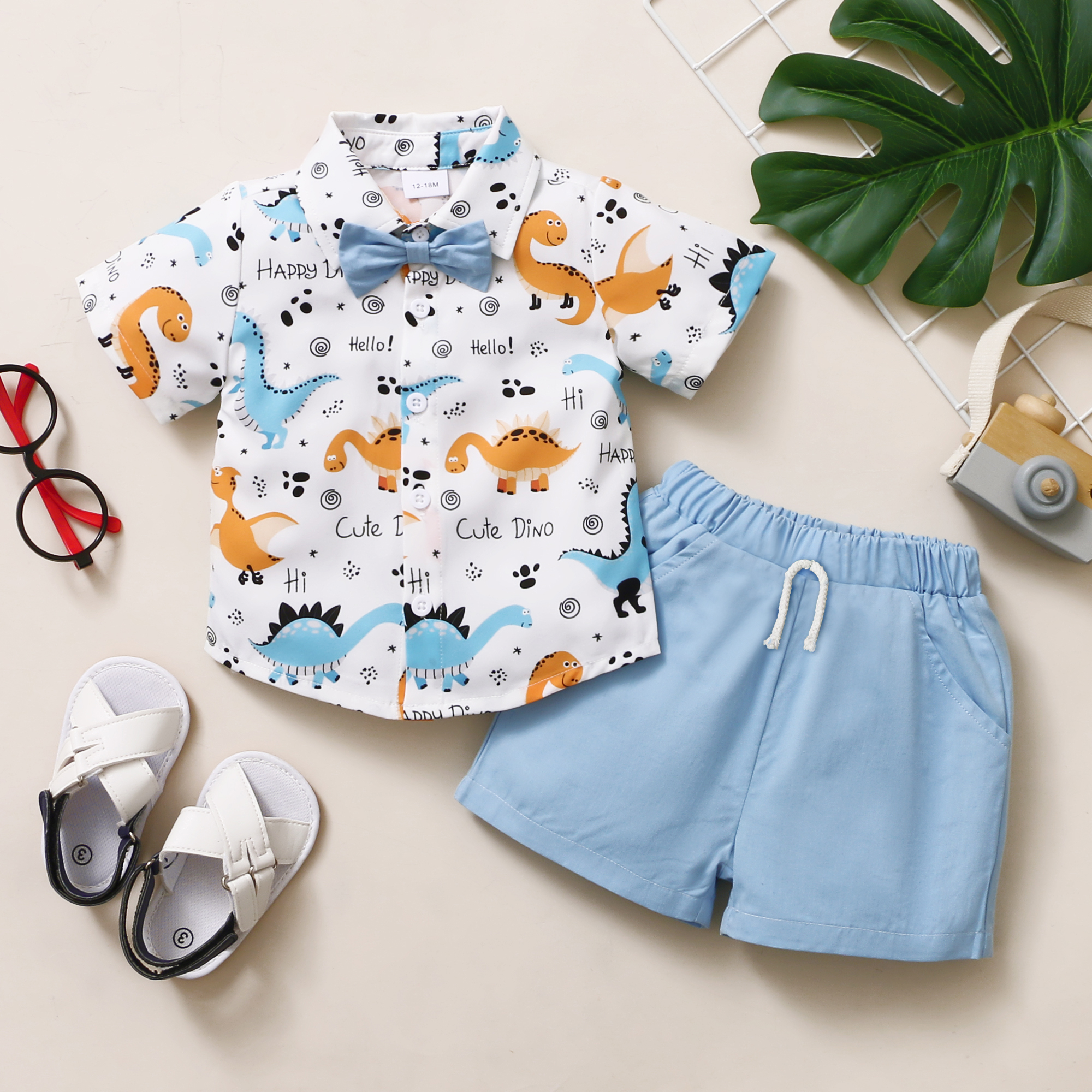 

2-piece Toddler Boy Dinosaur Print Short-sleeve Shirt with Bow tie and Elasticized Solid Blue 100% Cotton Shorts Set
