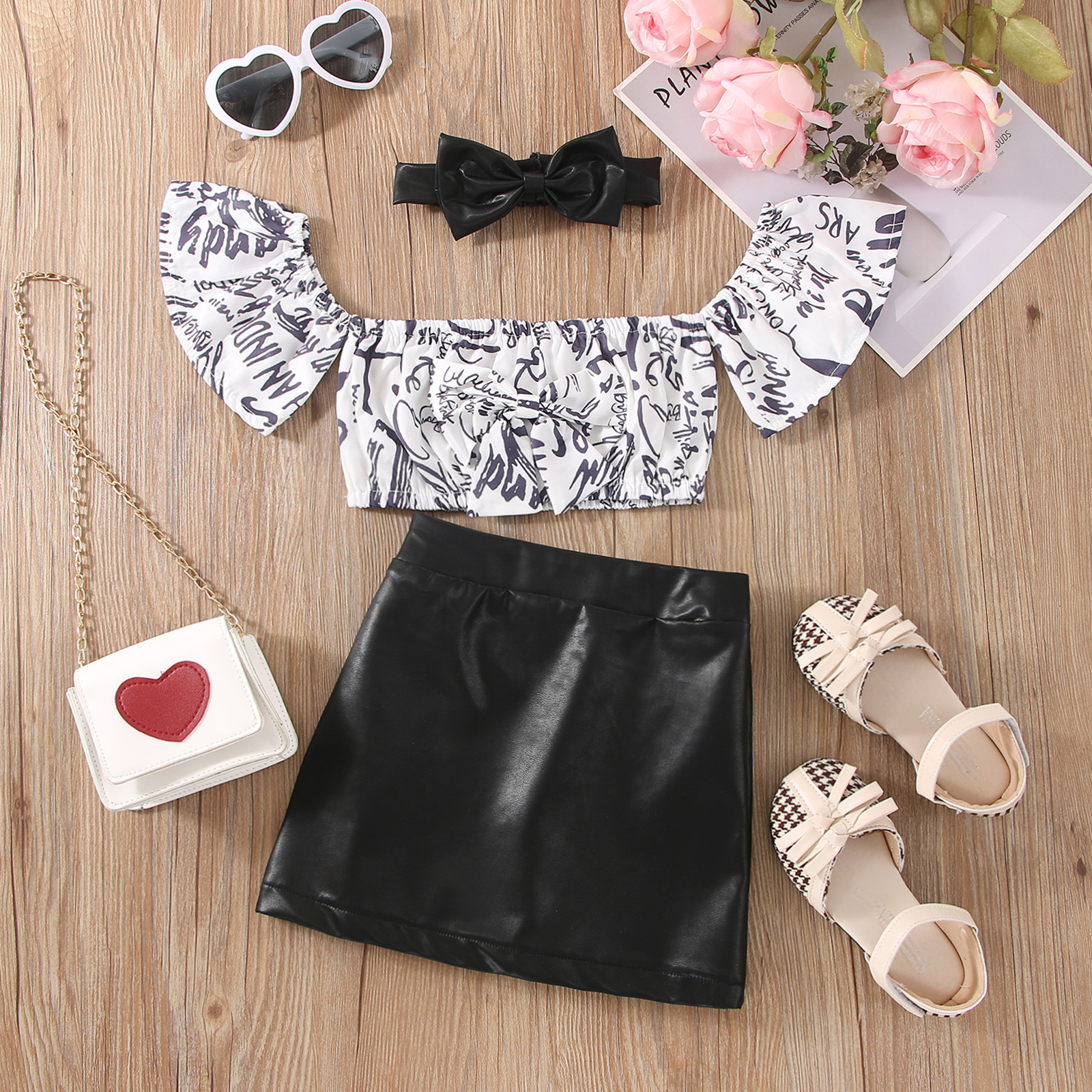 

2pcs Toddler Girl Allover Print Off Shoulder Bowknot Design Short-sleeve Top and Faux Leather Black Skirt Set