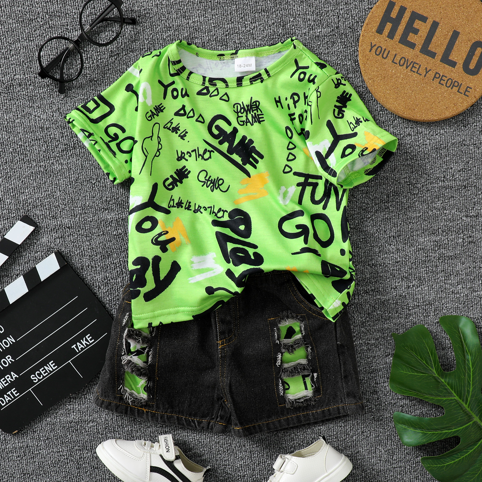 

2pcs Baby Boy 95% Cotton Ripped Denim Shorts and All Over Graffiti Letter Print Short-sleeve T-shirt Set